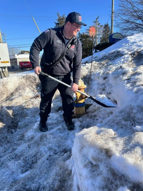 Firefighter Eoin Kavanaugh clears a fire hydrant after the February 2026 blizzard - Colchester, CT