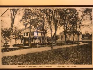 A historic postcard showing the Library in 1905 and the former Baptist parsonage, now home to the Colchester Historical Museum.