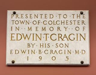 Carved marble plaque with gold lettering: "Presented to the Town of Colchester in Memory of Edwin T. Cragin by his Son..."
